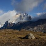 Stronger morning light hits a grass plateau, with the iconic Los Cuernos ‘horns’, of the Paine Massif, displayed behind (image by Virginia Wilde)