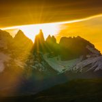 The sun starts to go down behind the towers (‘Torres’) of the Paine Massif, turning the lakeside water below orange (image by Virginia Wilde)