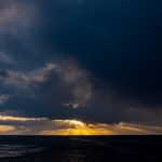 Sunrise bursts through the clouds at Gold Harbour (image by Inger Vandyke)