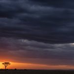 The sun being crushed out of the sky by a leaden blanket of storm clouds (image by Mike Watson)