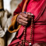 The hand of the 80 year old Rangdum Lama and his mala beads, constantly chanting om-mani-padme-hum as we visited (image by Julie-Anne Davies)