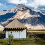 Our ‘tent’ home for the night on the outskirts of Rangdum (Rangdum Monastery in the background at the base of the mountain on the right). Our cozy tents came complete with hot showers and a flushing toilet! (image by Julie-Anne Davies)
