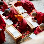 The young monks of Phugtal at their morning school session, just below the cave, high in the monastery (image by Julie-Anne Davies)