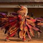 A running Egungun masked dancer (image by Inger Vandyke)