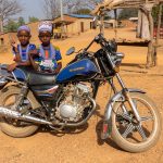 Young Fulani girls watch our group from the motorcycle owned by their head man (image by Inger Vandyke)
