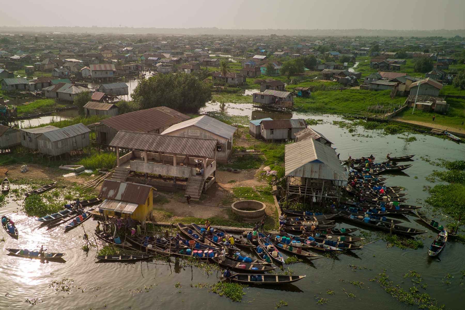 Although the city is rapidly being developed there is still no potable water in Ganvié, so its residents must fetch water to their homes by canoe from a central pumping station (image by Inger Vandyke)