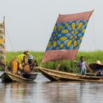 Brightly coloured sailing boats on Lake Nokué (image by Inger Vandyke)