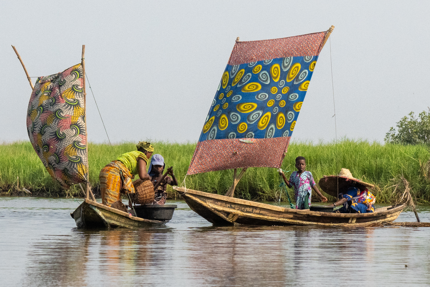 Brightly coloured sailing boats on Lake Nokué (image by Inger Vandyke)