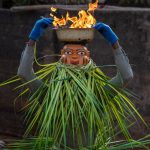 A Guèlèdè dancer reaches into his flaming bowl to grab live embers which he threw on the ground near our feet! (image by Inger Vandyke)
