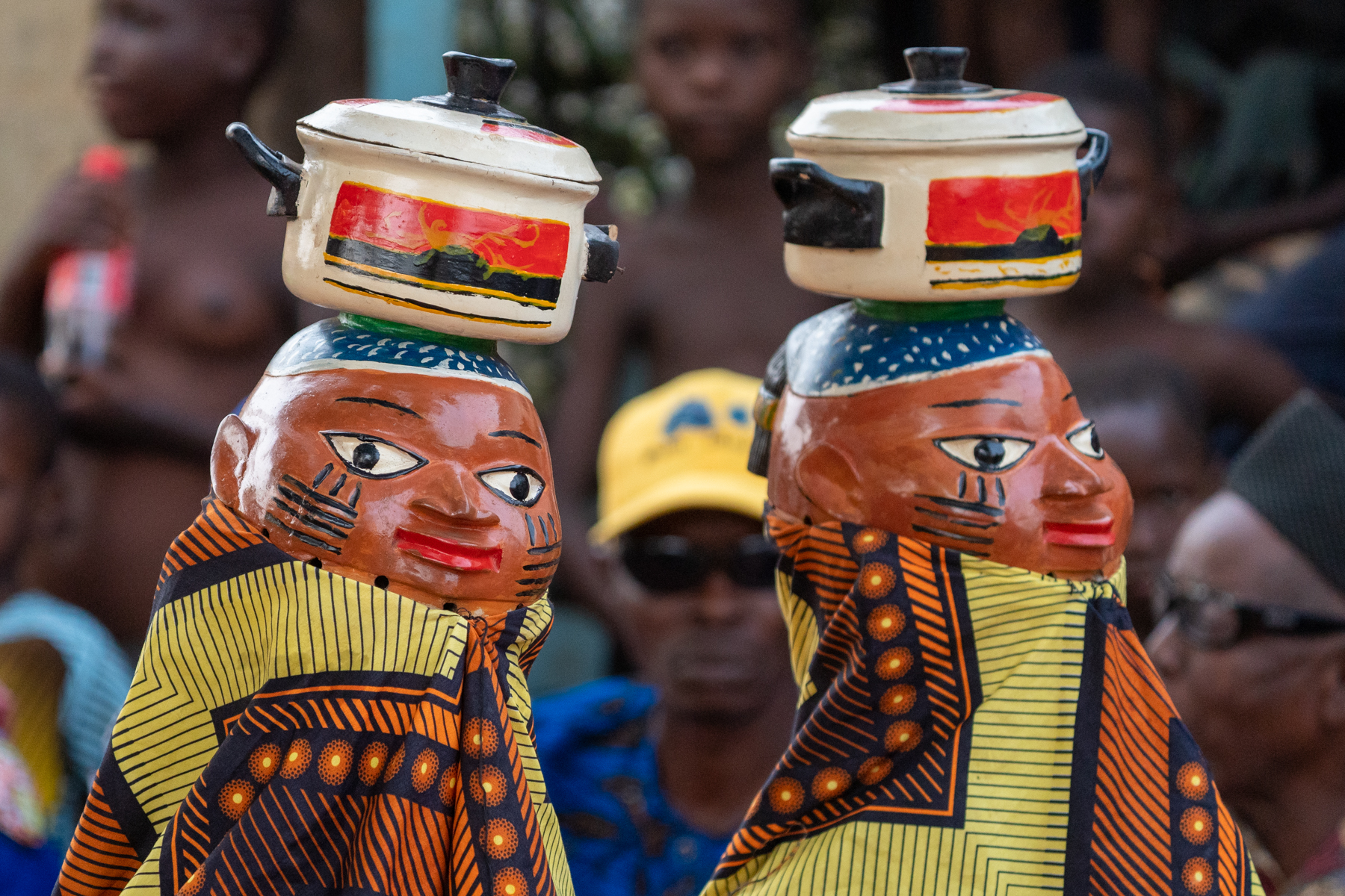 Guèlèdè dancers wearing masks depicting cooking at a private ceremony for our tour (image by Inger Vandyke)