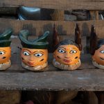 A line up of masks in the courtyard of a Guèlèdè mask carver (image by Inger Vandyke)