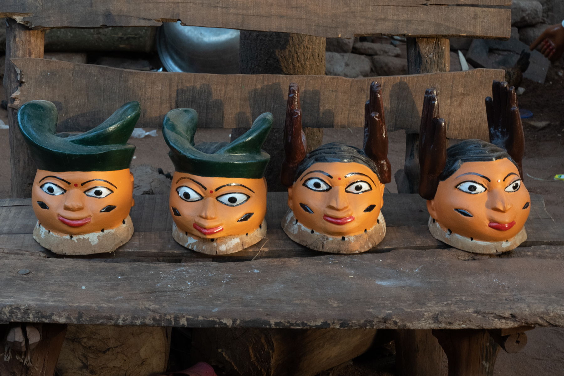 A line up of masks in the courtyard of a Guèlèdè mask carver (image by Inger Vandyke)