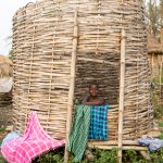 A pretty Holi girl sitting in the granary that is used to both store grain and dry washing! (image by Inger Vandyke)