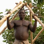 A local Holi man constructing the roof of his new home (image by Inger Vandyke)