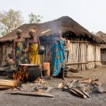 A group of Holi women preparing food over an open fire in their village (image by Inger Vandyke)