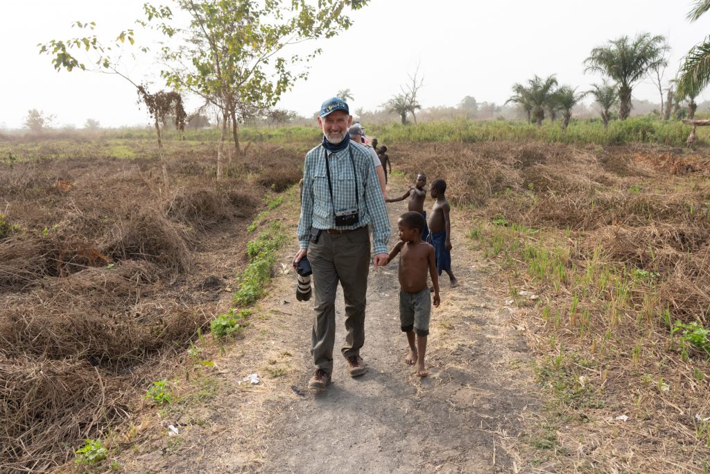 John walks into a Holi village with his newly appointed local guide (image by Inger Vandyke)