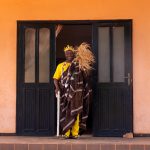 King Agassa, the highest figure of voodoo in the world, stands at the entrance of his home before we are granted a private audience with him (image by Inger Vandyke)