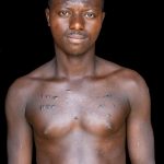 A scarred male Vodunsi groom in remote Benin (image by Inger Vandyke)
