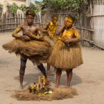 As Koku dancers approach the arena, they stop at a centrepiece to cover themselves in kaolin and palm oil (image by Inger Vandyke)