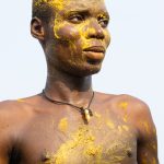 Portrait of a Koku dancer covered in kaolin and yellow palm oil, the trademarks of Koku celebrations (image by Inger Vandyke)