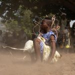 Beads flying as a Sakpata dancer lands after a somersault (image by Inger Vandyke)