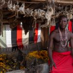 A Shango priest sits beside the main shrine of the Shango temple (image by Inger Vandyke)