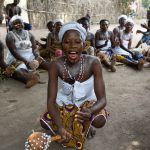 A beautiful young Vodunsi sings at a ceremony to welcome us in remote Benin (image by Inger Vandyke)