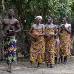 A young man serenades the arrival of Vodunsi voodoo brides (image by Inger Vandyke)