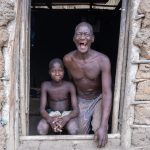 A giggling father and son in a village of Vodunsi (image by Inger Vandyke)