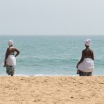Voodoo is sometimes described as 'he who belongs to the sea'. Two voodoo adepts watch the ocean at the conclusion of the festival (image by Inger Vandyke)