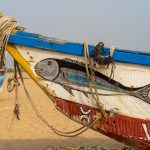 Brightly painted wooden fishing pirogues adorn the beaches near Cotonou (image by Inger Vandyke)