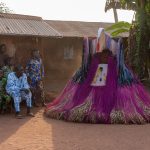 A backlit Zangbeto enters the ceremony (image by Inger Vandyke)
