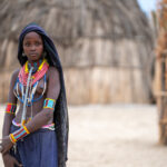A contemplative young Arbore girl in her village at dusk (image by Inger Vandyke)
