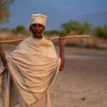 An Arbore elder returns from herding livestock at sunrise (image by Inger Vandyke)
