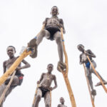 Young Benna boys walk over me on their wooden stilts (image by Inger Vandyke)
