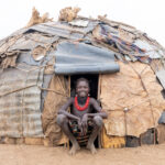 Portrait of a smiling Dassanech girl in the door of her home (image by Inger Vandyke)