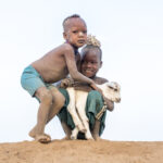 Karo children tussle over who gets to pet their baby goat (image by Inger Vandyke)