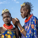 Karo girls painting their signature Guineafowl patterns (image by Inger Vandyke)