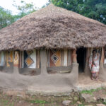The hand painted walls of a Maji tukul house. These beautiful murals are usually created by local women (image by Inger Vandyke)