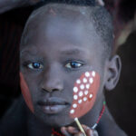 The delicated dot painting of Mursi people (image by Inger Vandyke)