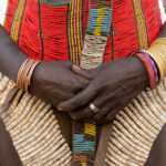 The stunning beauty of Nyangatom decoration includes brass and copper bracelets, handmade beaded belts and skirts (image by Inger Vandyke)