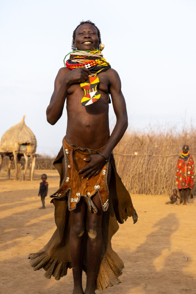 A Nyangatom woman breaks into a spontaneous dance during our visit. It was so beautiful! (image by Inger Vandyke)