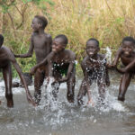 Young Suri boys splashing and playing in the Kibish River (image by Inger Vandyke)