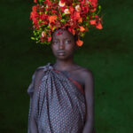 An ethereally beautiful Suri girl with her headdress of fresh poinciana flowers (image by Inger Vandyke)