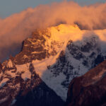 The clouds are ripping up and provide a view on the spectacular mountains (image by Bernd Rohrschneider)
