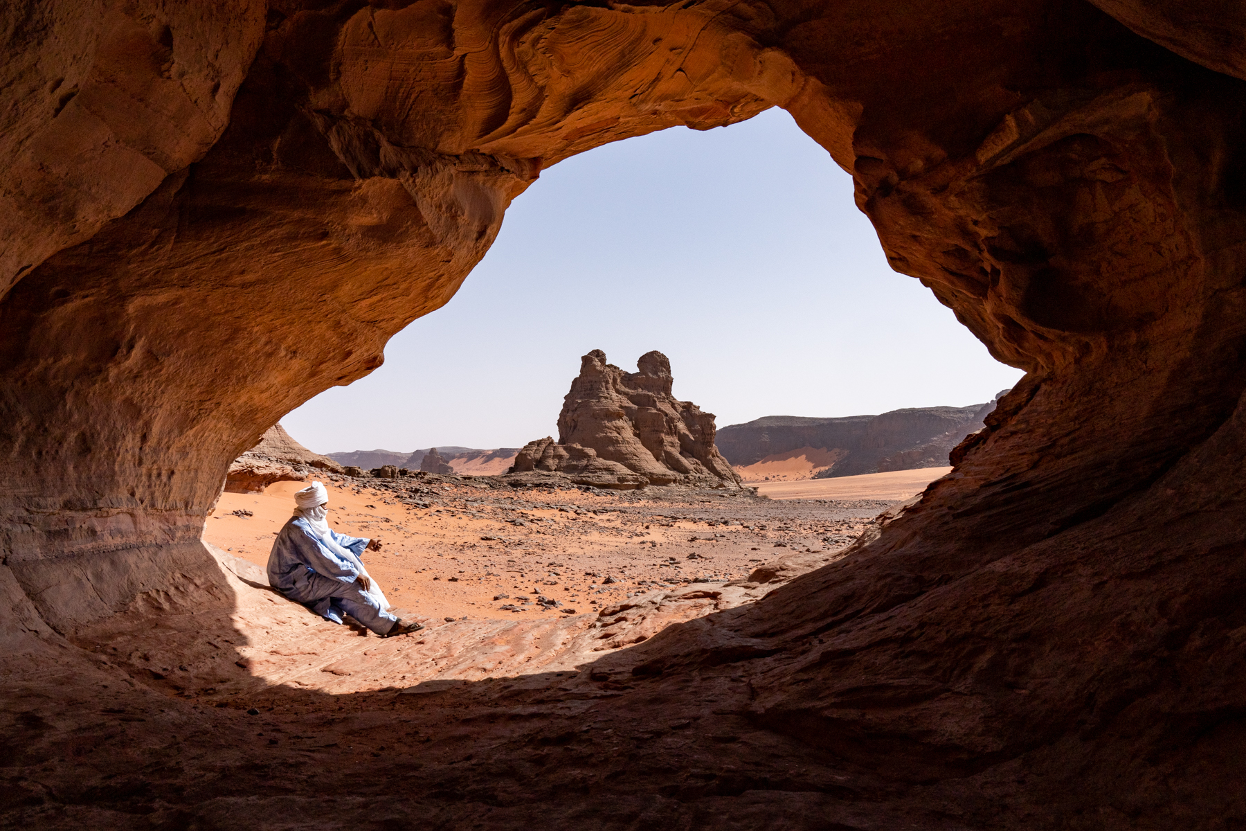Our guide sits in one of the many rock arches we will visit on our tour (image by Inger Vandyke)