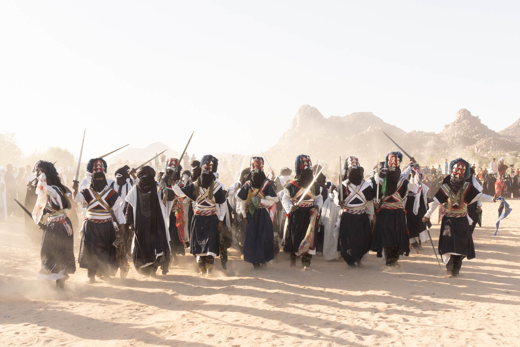 Dancing in the dust. Warriors celebrating Sabiba, a UNESCO world heritage listed event for its importance to Tuareg and Algerian culture A Sabiba warrior talks to his son to prepare him for the friendly battle of the Sabiba ceremony (image by Inger Vandyke)