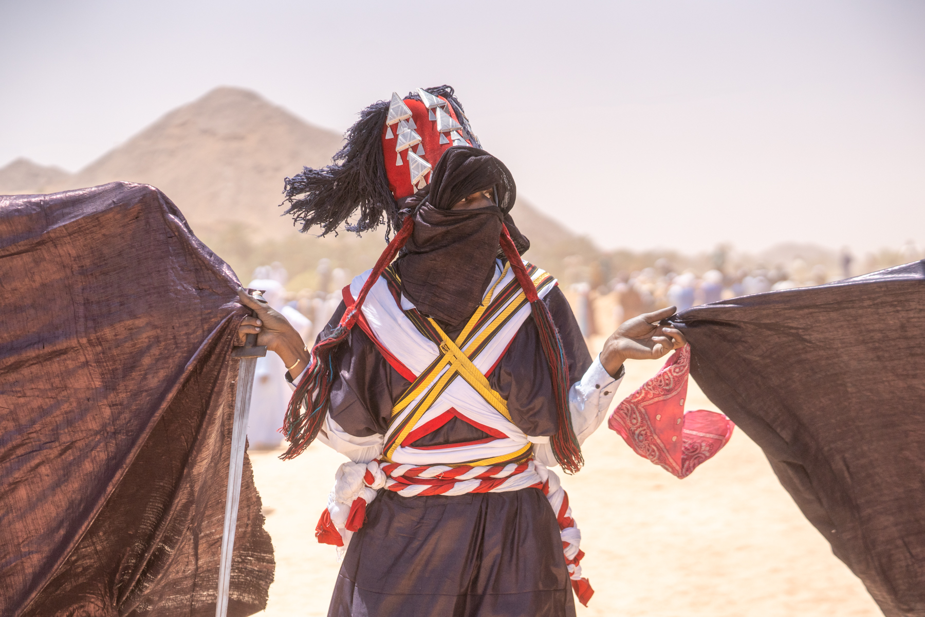 A Sabiba warrior holds swathes of indigo-dyed fabric as part of the ceremony in Djanet (image by Inger Vandyke)