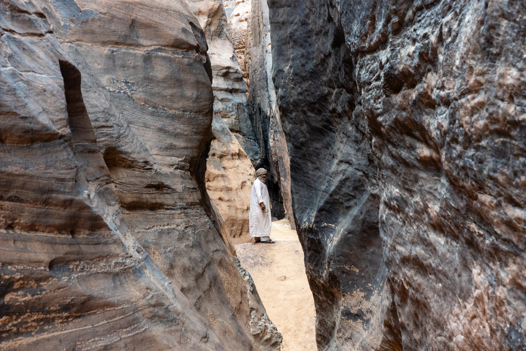 Exploring a gigantic slot canyon in Tadrart Rouge (image by Inger Vandyke)