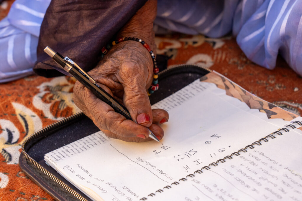 Learning Tiffnagh language with an elderly Tuareg lady (image by Inger Vandyke)